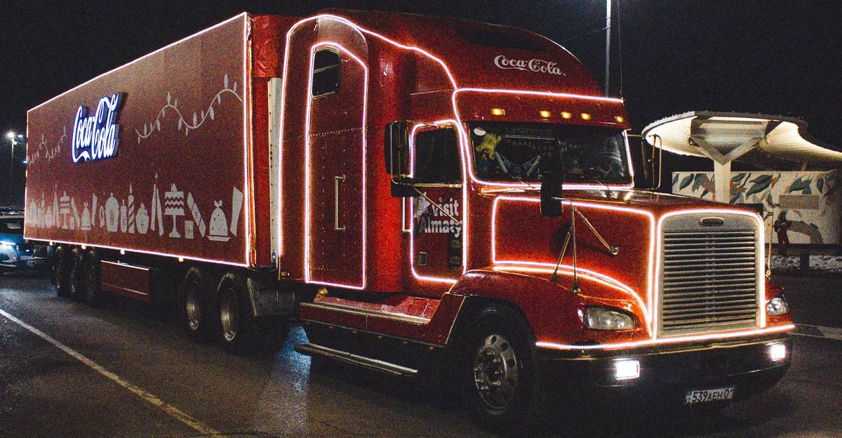 Coca-Cola Christmas truck lit up at night representing AI-generated advertising