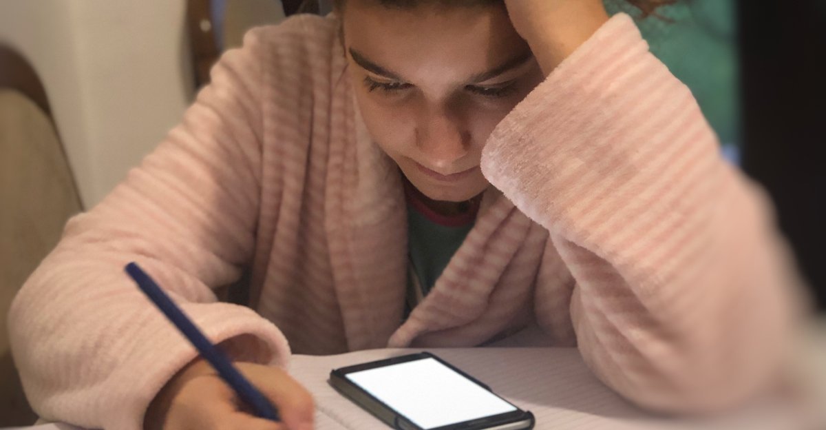Teenager doing homework on her phone representing using AI tools before we knew they were AI