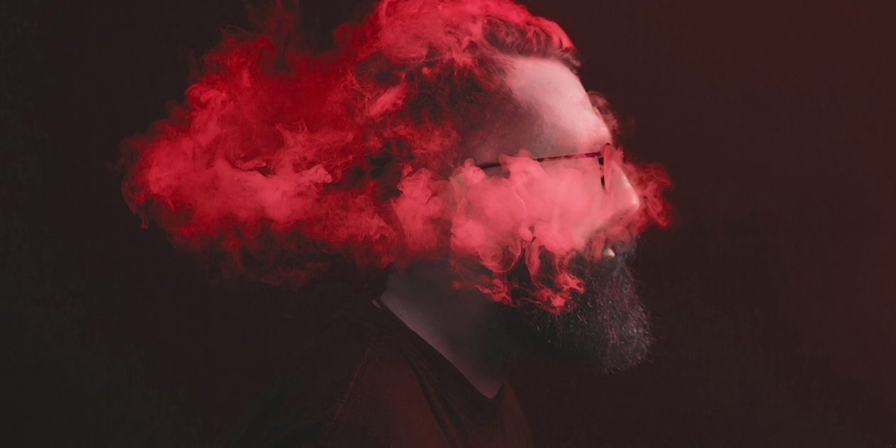stressed-designer-head-in-clouds A man with red smoke obscuring his head — a stressed designer working without a clear brief