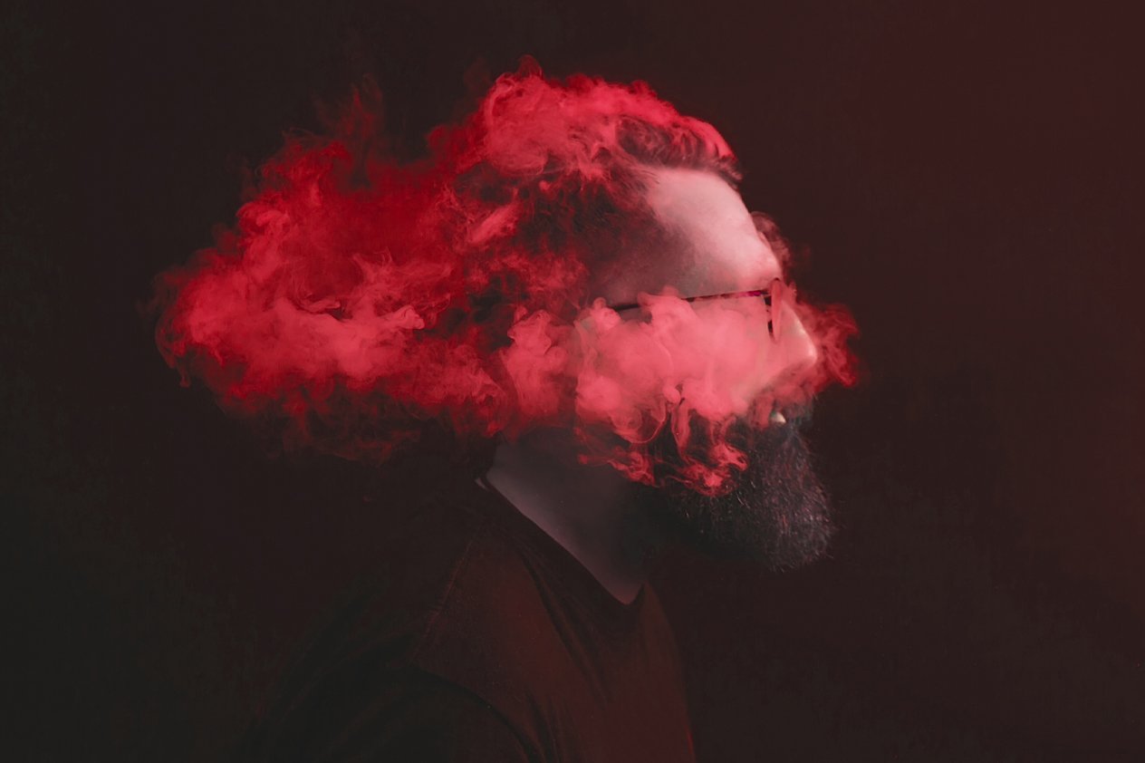 stressed-designer-head-in-clouds A man with red smoke obscuring his head — a stressed designer working without a clear brief